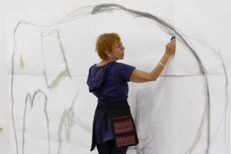 Amy Dapice, our sketch artist extraordinare, creates a mural on the wall during the Lifelong Learning Payap Open House 2024