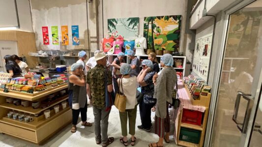 Participants at the Lifelong Learning Payap Bean to Bar event with Siamaya Chocolate examine the array of chocolate bars the company produces