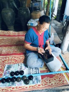 Excursion to Tai Khuen, Tai Yong, and Tai Lue Communities sat on floor