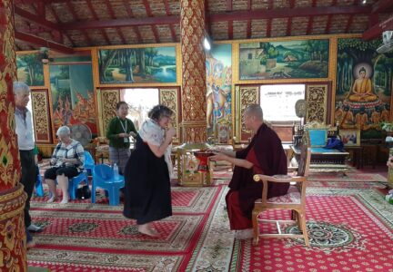 Excursion to Tai Khuen, Tai Yong, and Tai Lue Communities atendees and monk