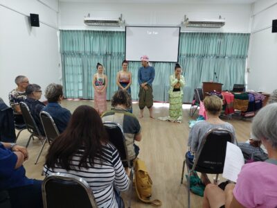 Textiles and Lanna Dance group watching performance