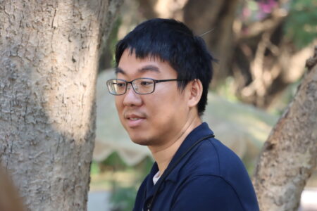 A participant on a campus walk was discussing trees and plants.