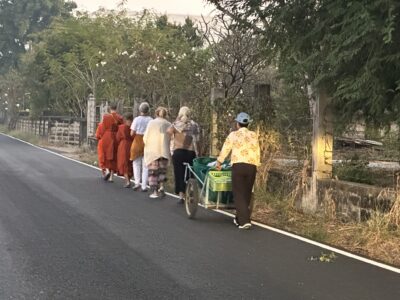 Buddhist nuns and laypeople on an alms round at Songdhammakalyani Monastery, Thailand