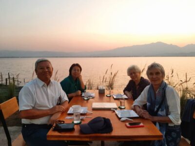Enjoy a serene lakeside sunset dinner in Phayao with breathtaking mountain views.