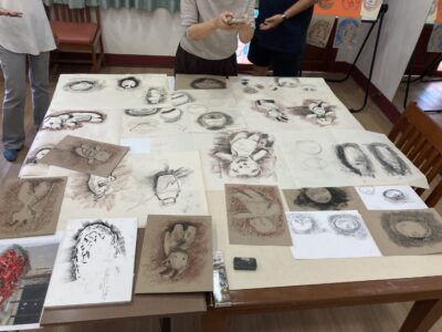 Charcoal and Pastel Artworks on Display.
