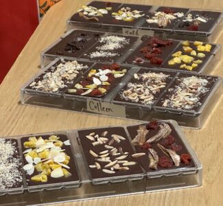 Several chocolate bars with different toppings like fruits, nuts, and spices, all carefully made during the workshop at Siamaya Chocolate Factory.