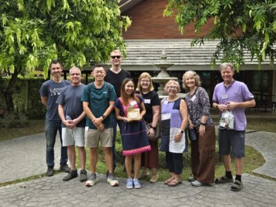 The Lifelong Learning group gathers for a commemorative photo, celebrating their excursion from crop to cup with Lanna Coffee.