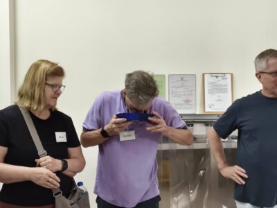 A participant named Robert evaluates the aroma of coffee during a professional cupping and sensory session.